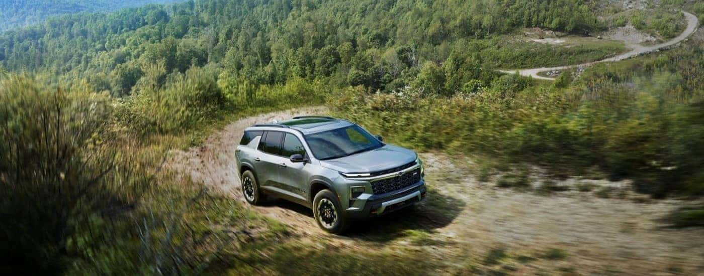 Silver 2026 Chevy Traverse Z71 driving up a trail