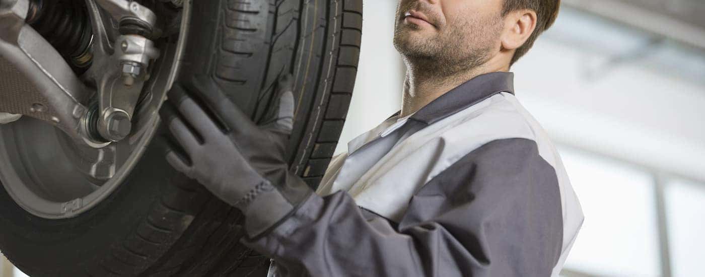 A mechanic changing the tire on a vehicle