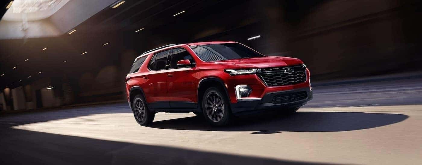 Red 2023 Chevy Traverse RS driving through a tunnel