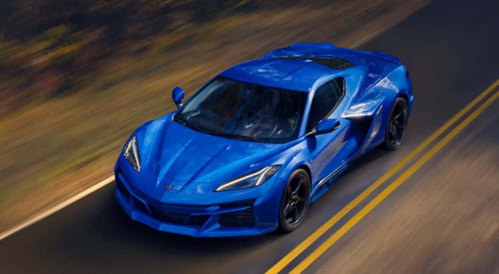 Blue 2026 Chevy Corvette E-Ray bird's eye view as it drives down the road