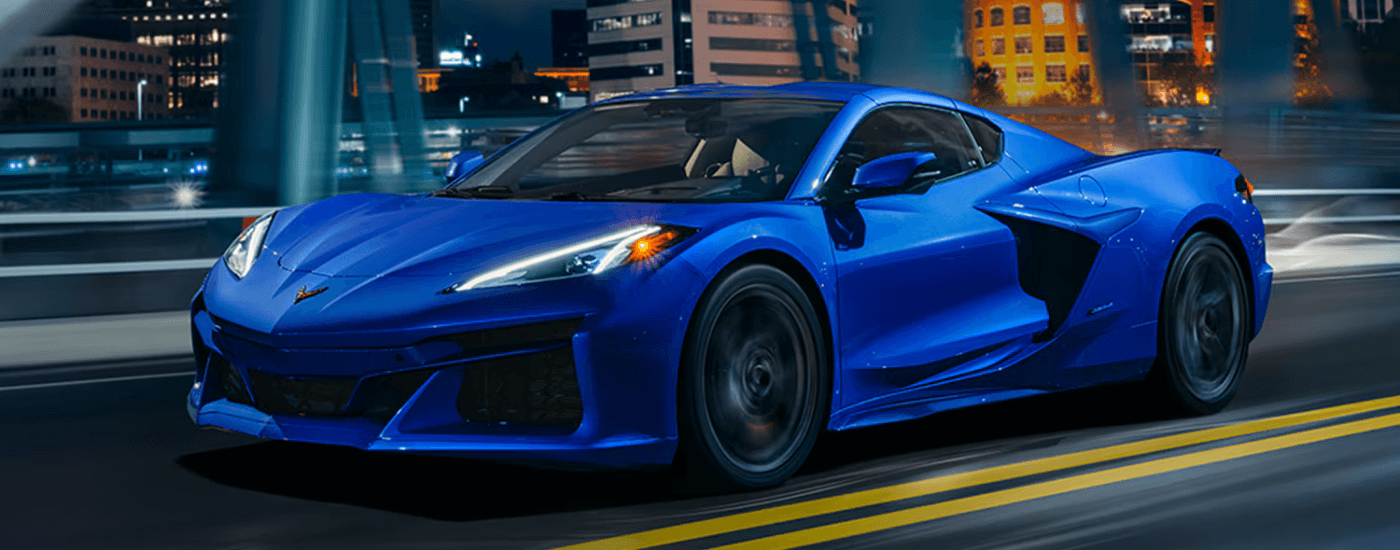 Blue 2026 Chevy Corvette E-Ray driving over a bridge