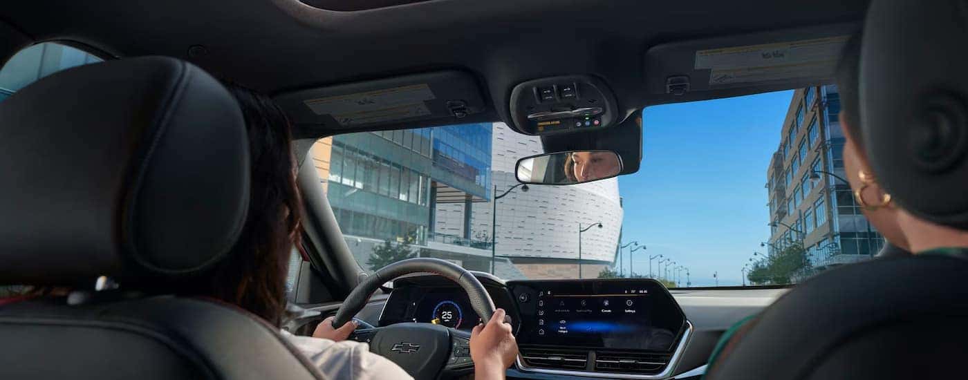 Two people driving in a 2026 Chevy Trax