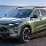 Green 2026 Chevy Trax parked in front of a lake