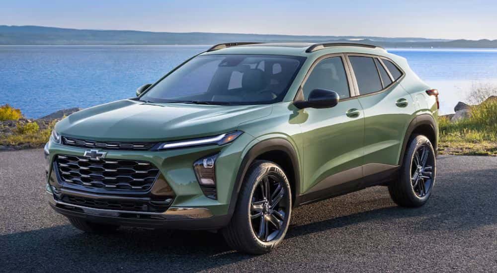 Green 2026 Chevy Trax parked in front of a lake