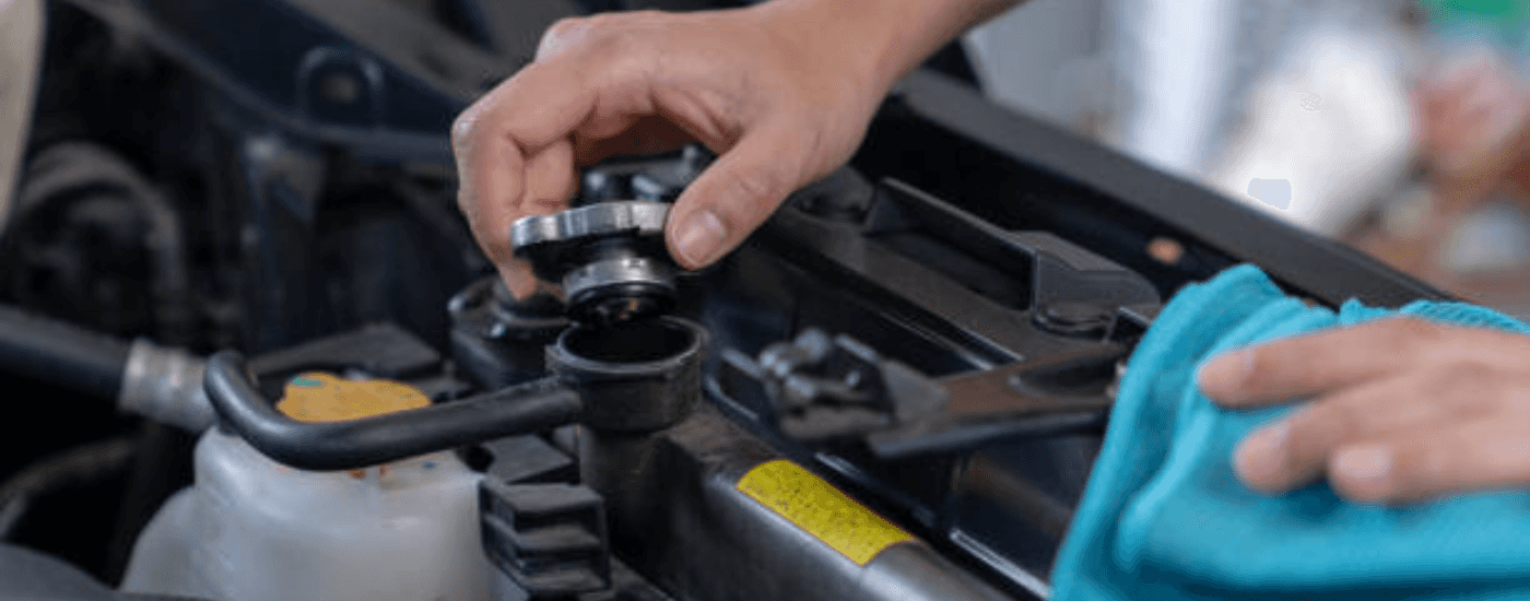 A mechanic checking fluid levels