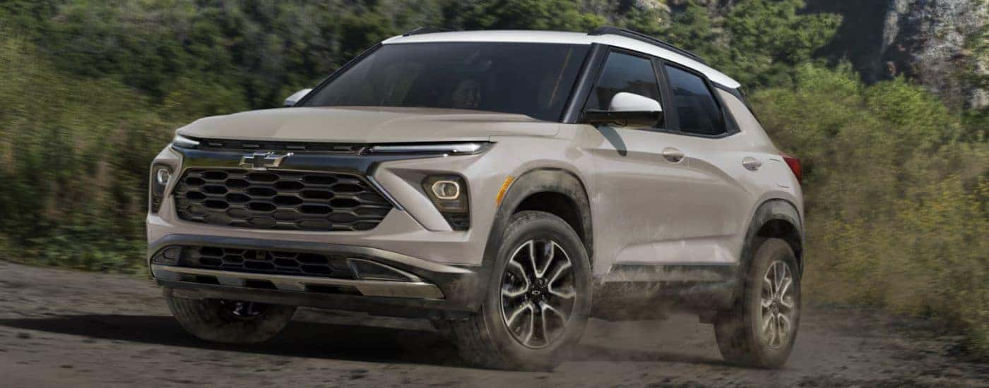 Tan 2026 Chevy Trailblazer driving through the woods.