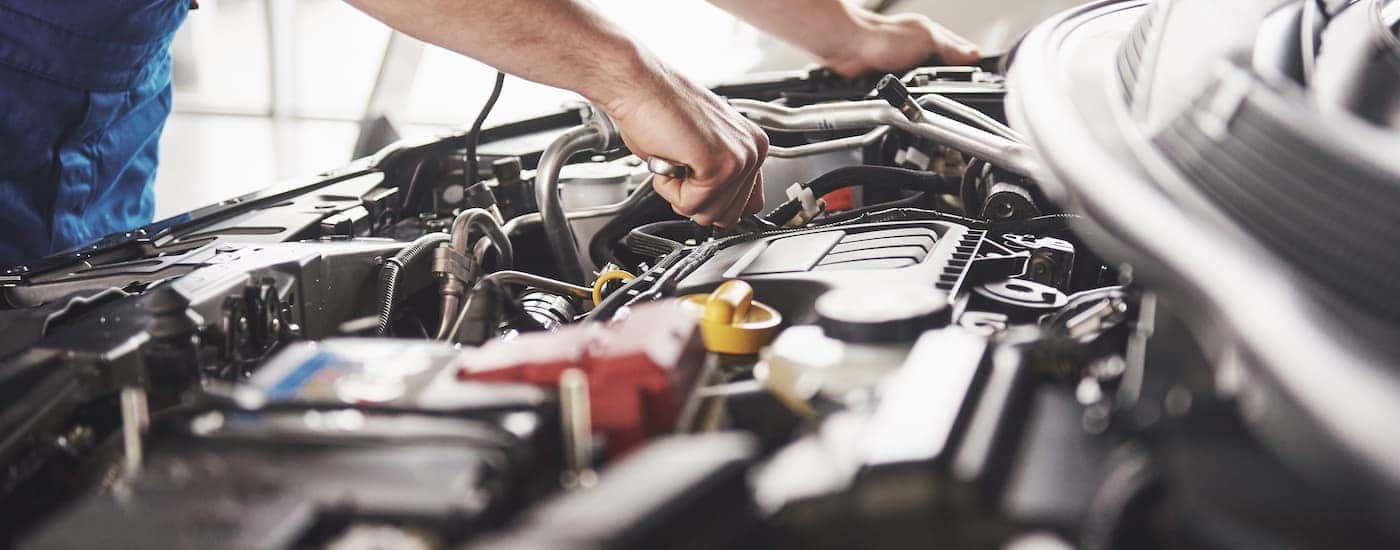 A service technician checking fluids in a car