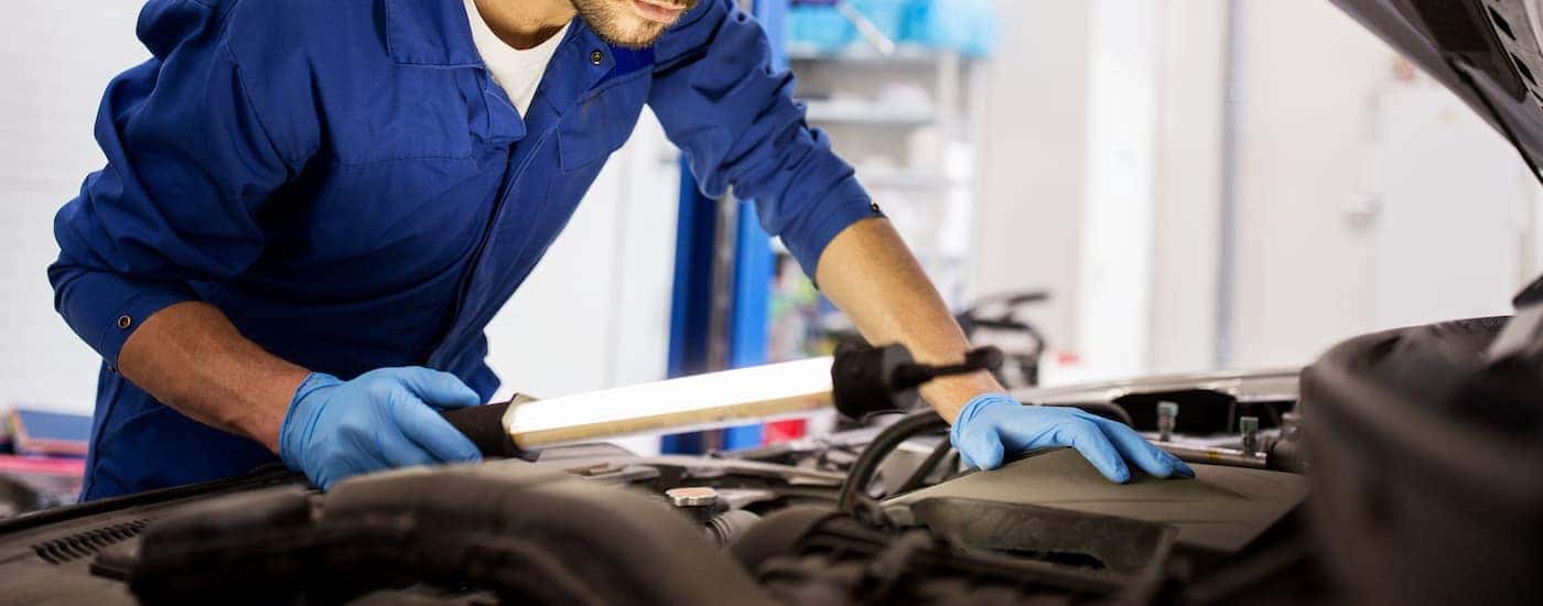 A mechanic inspecting the engine fluids