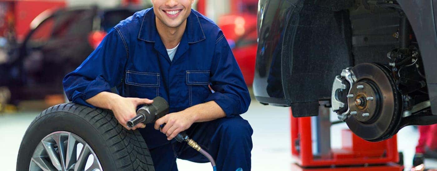 A service technician preparing to install a tire