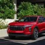 A red 2026 Chevy Trax parked next to a building.