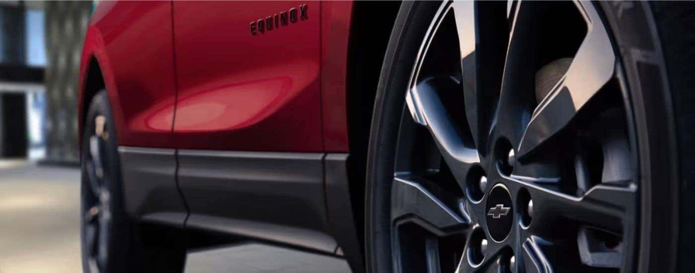 Black wheels on a red 2023 Chevy Equinox RS