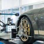 Wheel Alignment on a green vehicle with the computer shown.