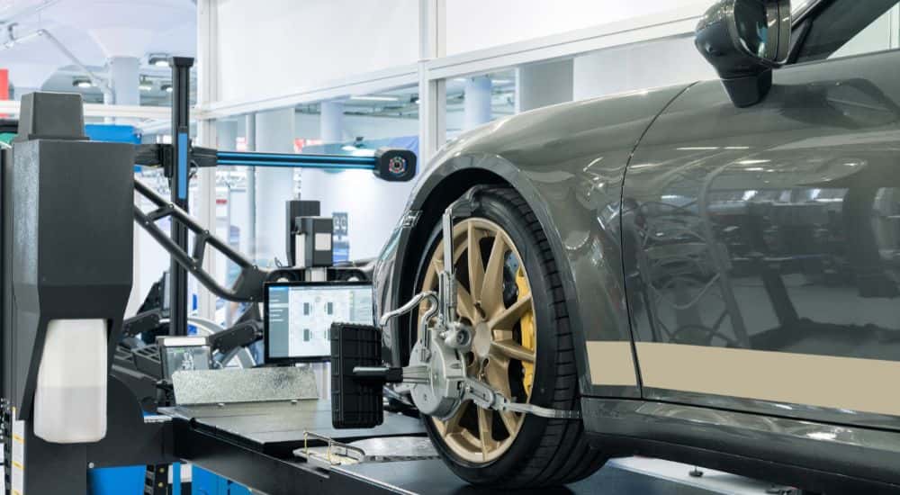 Wheel Alignment on a green vehicle with the computer shown.