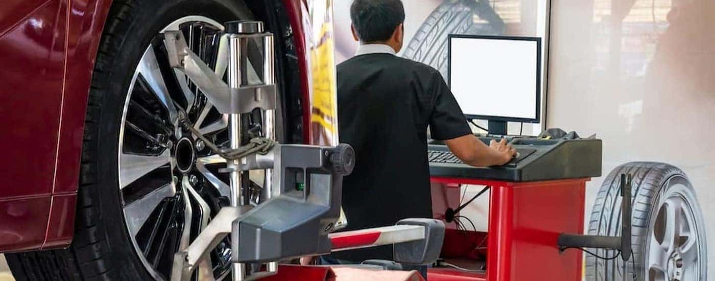 A technician performing a wheel alignment.