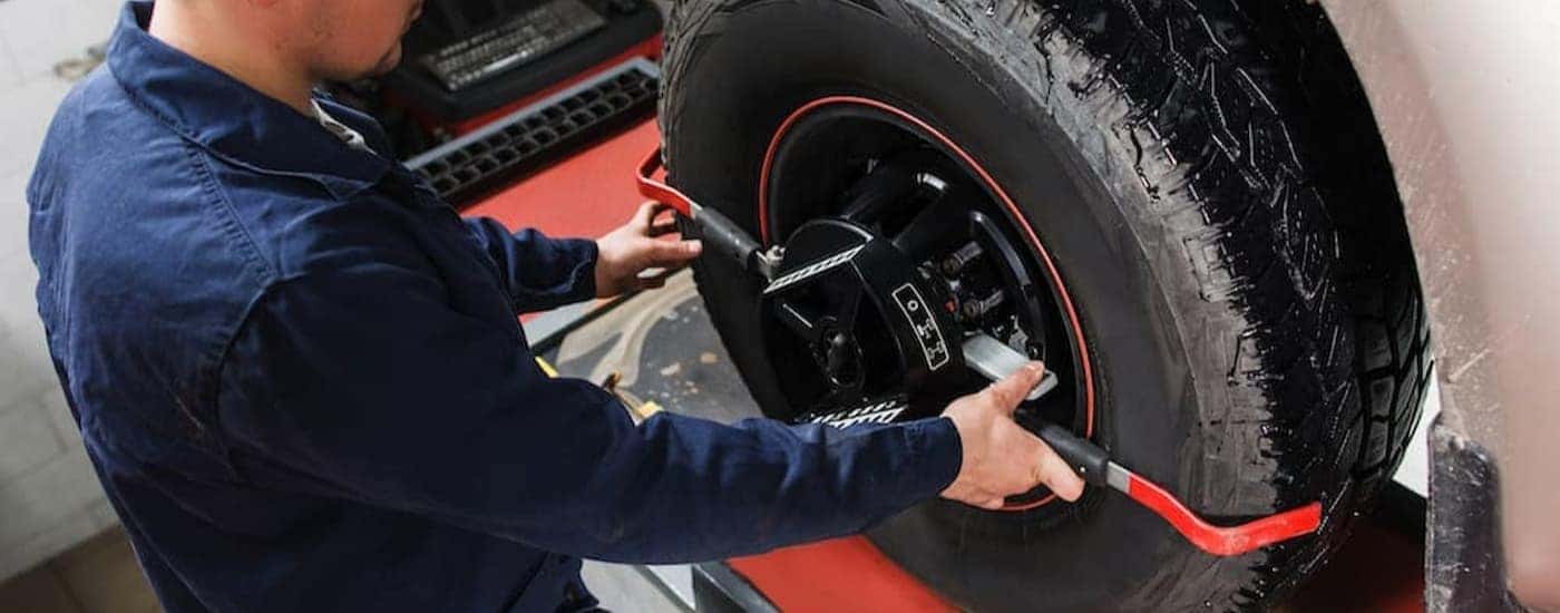 A technician performing a wheel alignment.