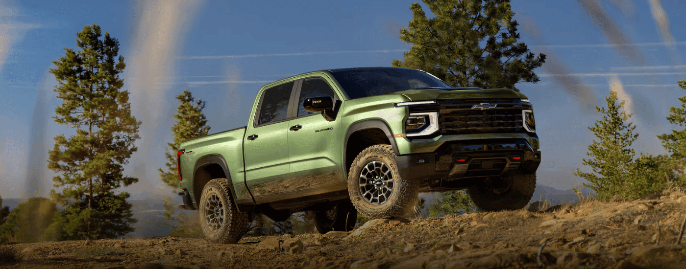 Green 2027 Chevy Silverado 1500 parked off-road at an angle