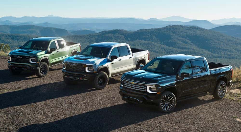 A green, white and black 2027 Silverado Trio parked.