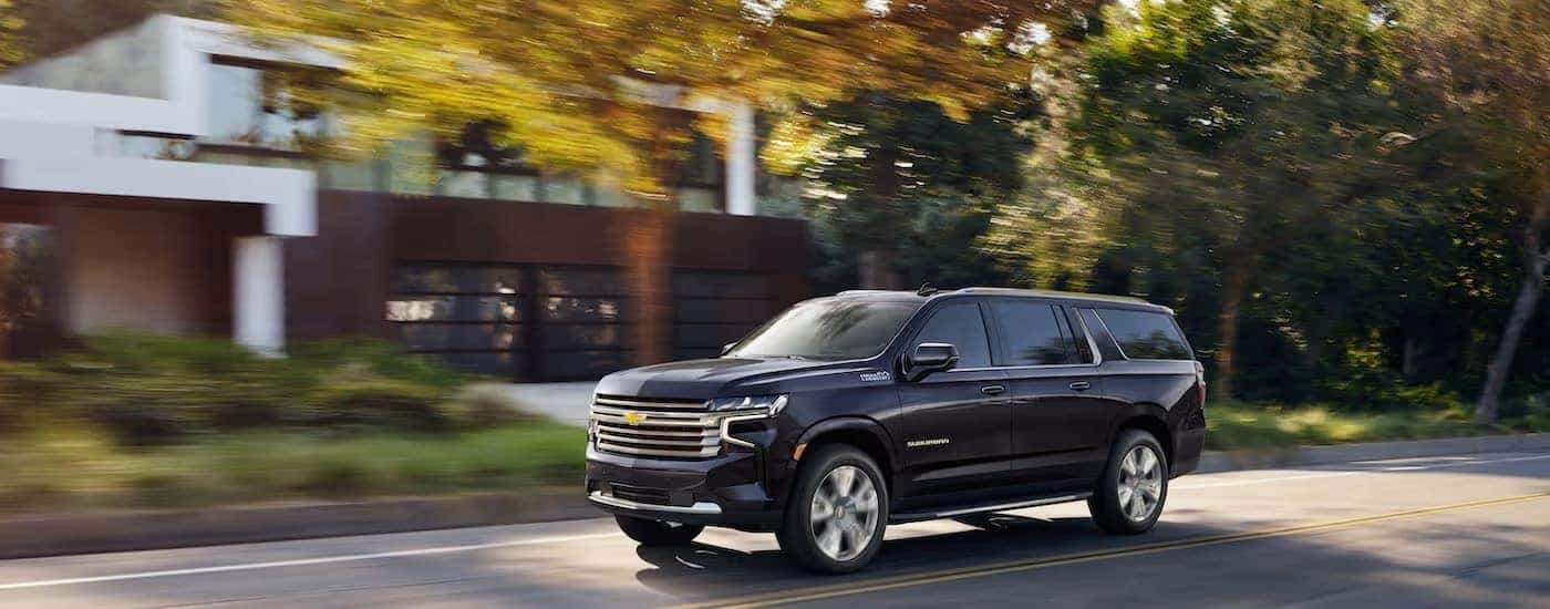 A black 2022 Chevy Suburban is shown from the side.
