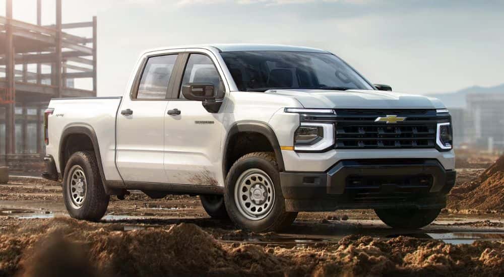 A white 2027 Silverado 1500 parked at a construction site.