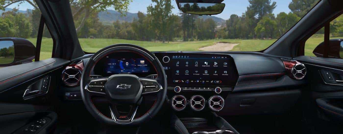 Interior view of a 2026 Chevy Blazer EV infotainment system, steering wheel & digital gauge cluster.