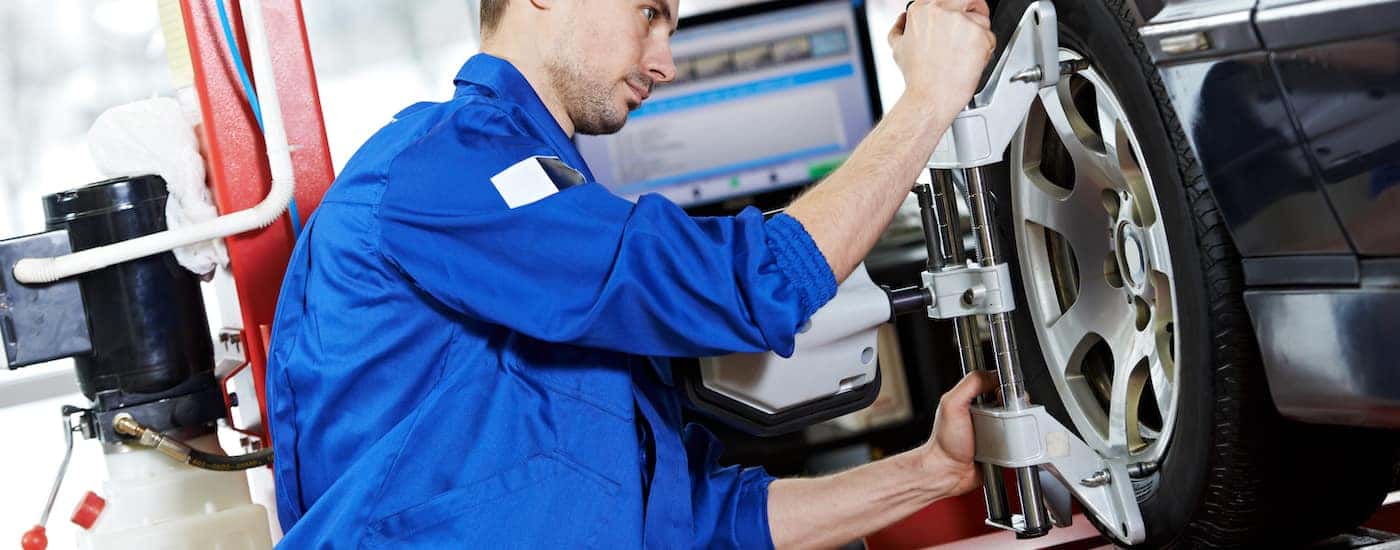A service technician conducting a wheel alignment.