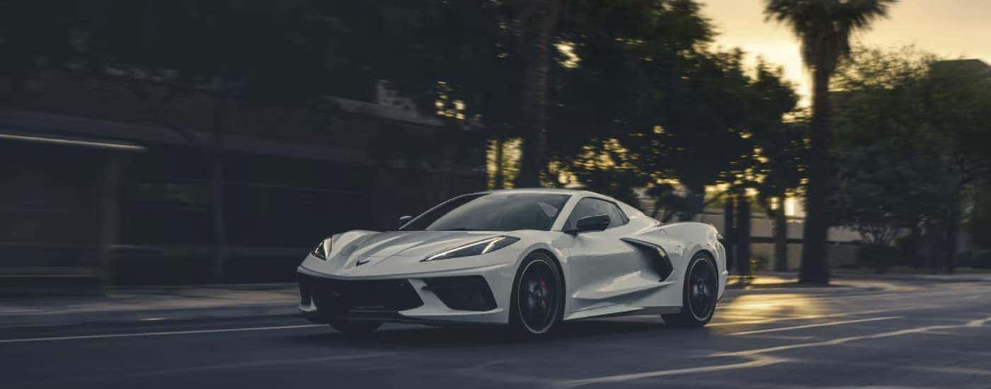 A white 2027 Chevy Corvette driving in a city