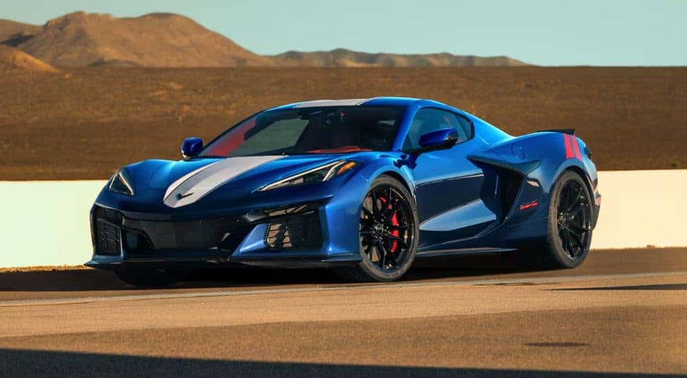 A blue 2027 Chevy Corvette Grand Sport 3LT Coupe parked on a track.