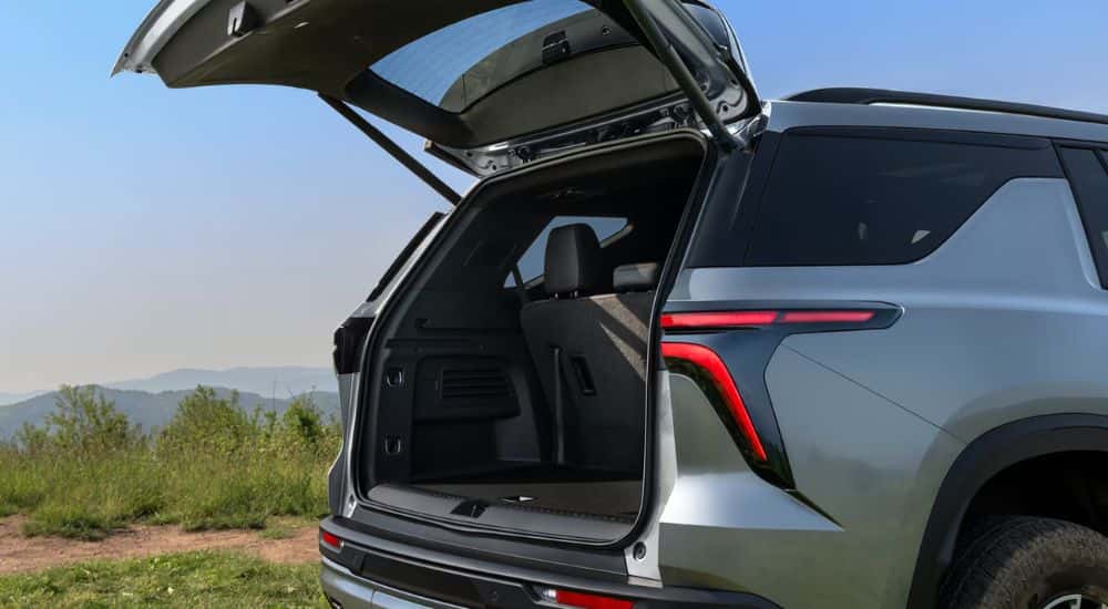 A gray 2026 Chevy Traverse Z71 parked mountainside with rear gate open.