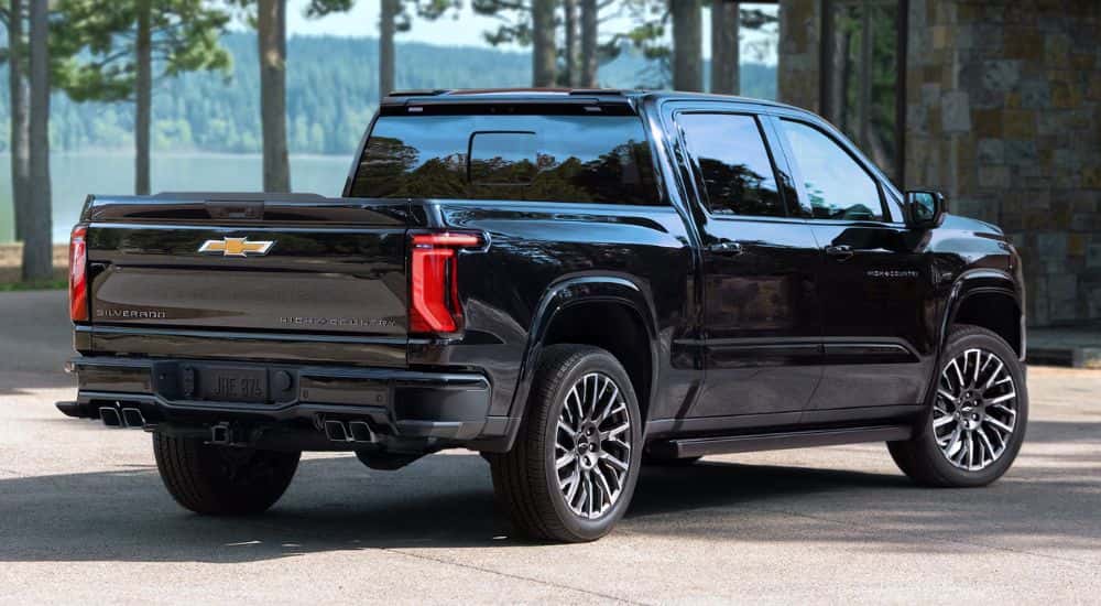 A black 2027 Chevy Silverado 1500 High Country parked near a lake
