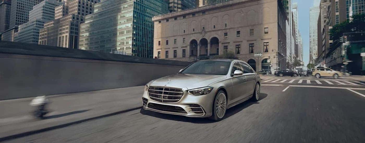Silver 2023 Mercedes-Benz S class driving down the street