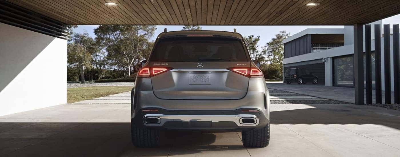 Rear view of a silver 2020 Mercedes-Benz GLE 450 parked in a carport.