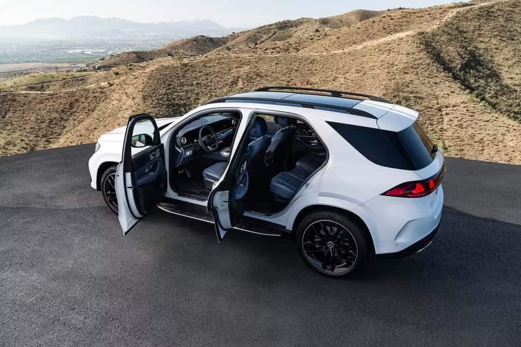 White Mercedes-Benz GLE SUV with its doors open, rear three-quarter view from above