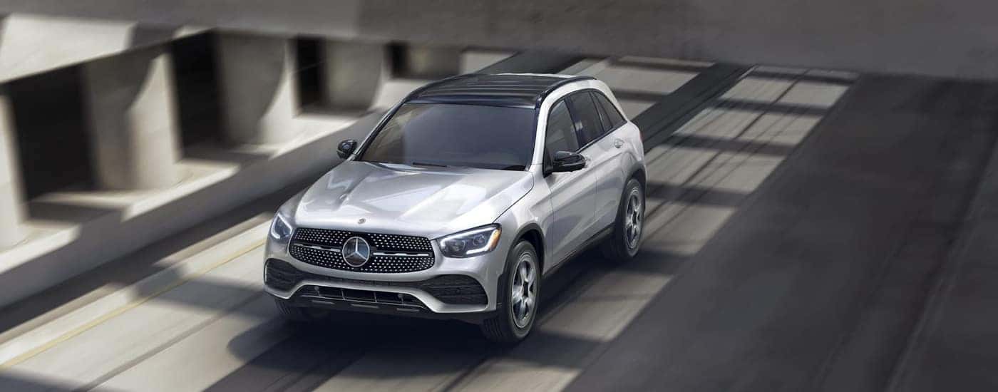Silver 2022 Mercedes-Benz GLC driving under and overpass