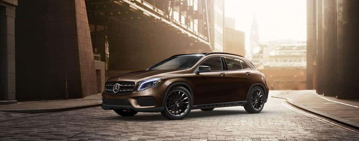 Dark brown 2020 Mercedes-Benz GLA parked near a bridge.