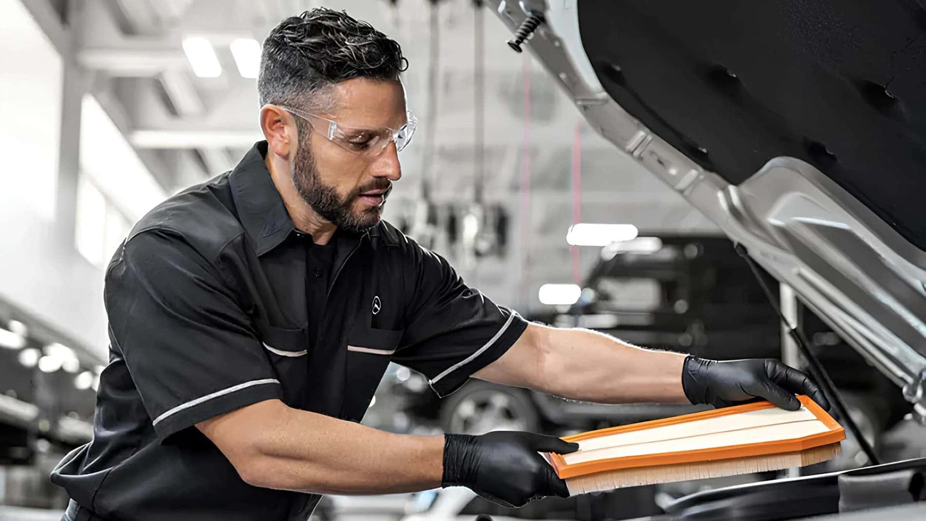 Certified technician replacing a Mercedes-Benz cabin filter during Service B at Mercedes-Benz of Richmond