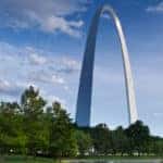 St. Louis Arch at day time with blue sky, clouds, and park