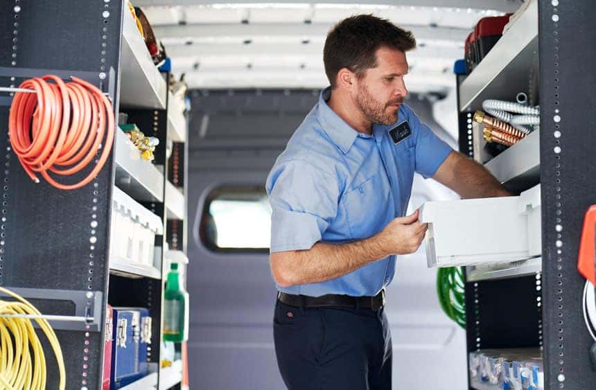 Workman in the back of Metris van