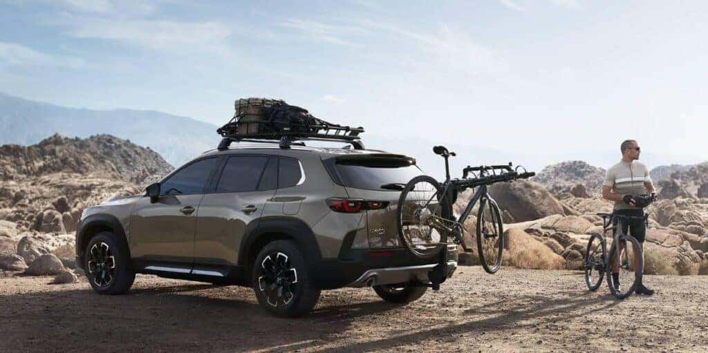 image of the back rear left of the mazda cx-50 with a bike rack on an adventure