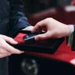 hand taking Mazda key fob out of a box