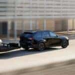 2026 Mazda CX-70 towing a trailer with a sports car