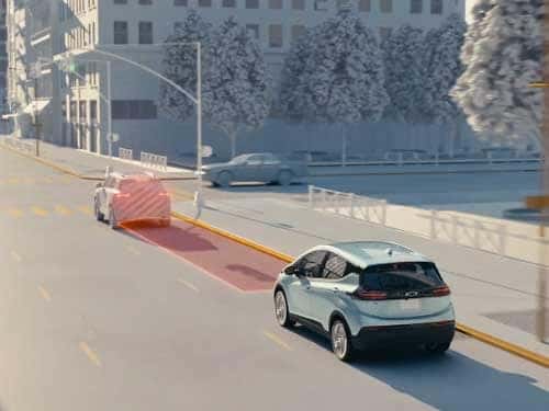 2023 Chevrolet Bolt EV driving on road with forward collision alert safety feature