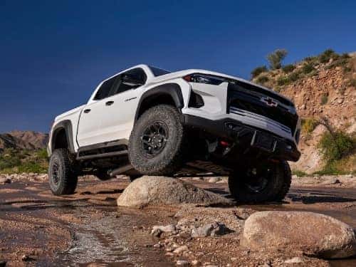 2024 Chevy Colorado driving over large rocks