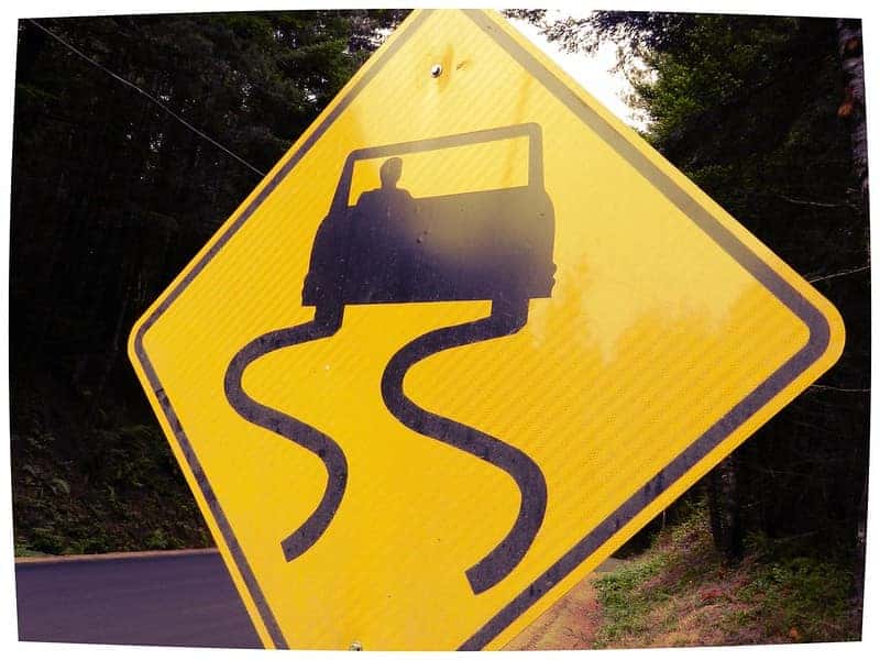 slippery when wet yellow road sign