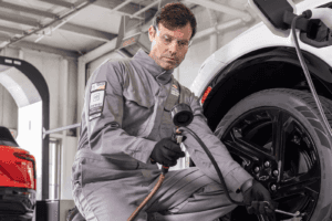 maintenance tech running diagnostics on ev chevy
