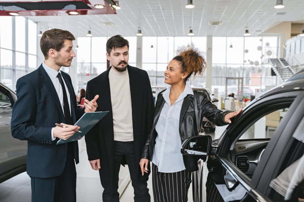 Man-in-Blue-Business-Suit-Talking-to-Woman-Touching-the-Car