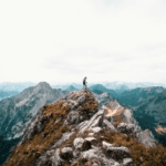 person standing on mountain during daytime