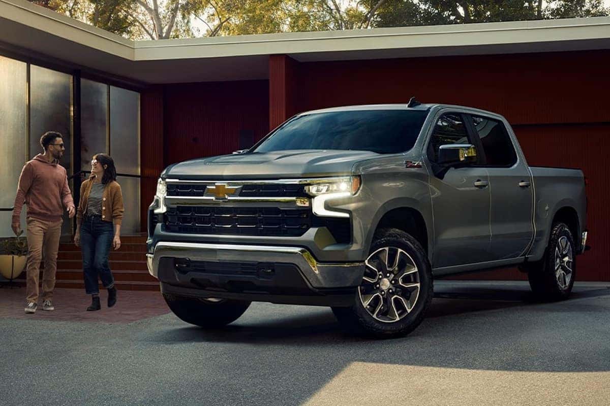 2025 silverado parked in driveway next to couple