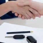 two people in an auto group shaking hands