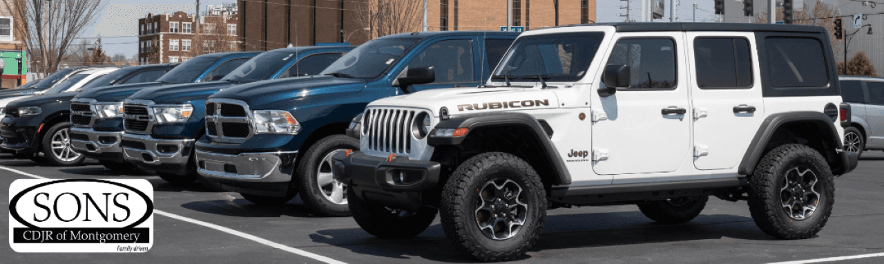 A photo of a white Jeep Wrangler Unlimited Rubicon and Ram trucks portraying a wide selection of used vehicles for sale at SONS CDJR Fiat in Montgomery, AL.