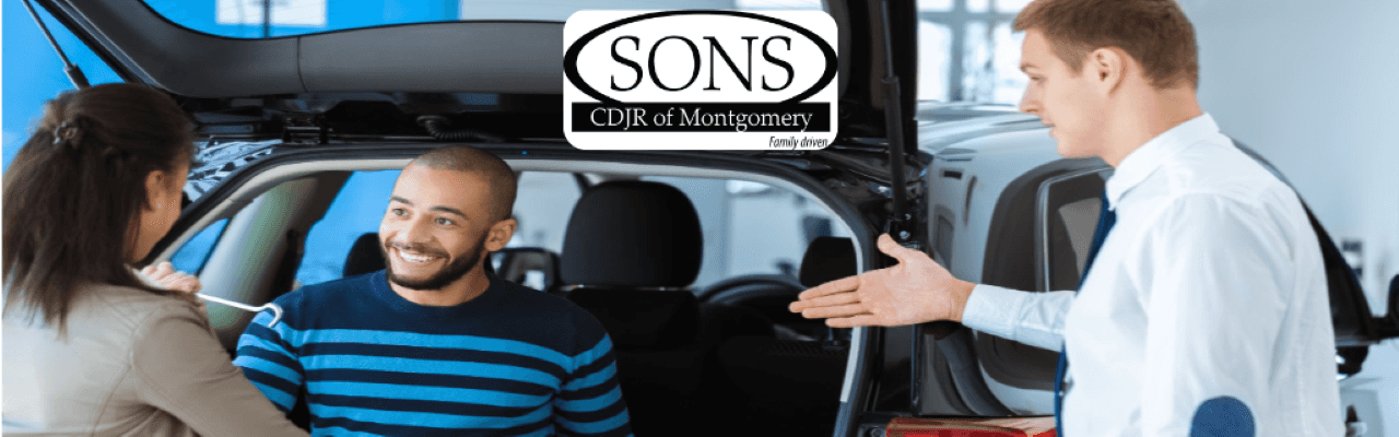 A happy customer receiving a check after trading in their car at SONS CDJR of Montgomery.